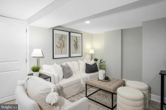 a living room with furniture and a wall painting