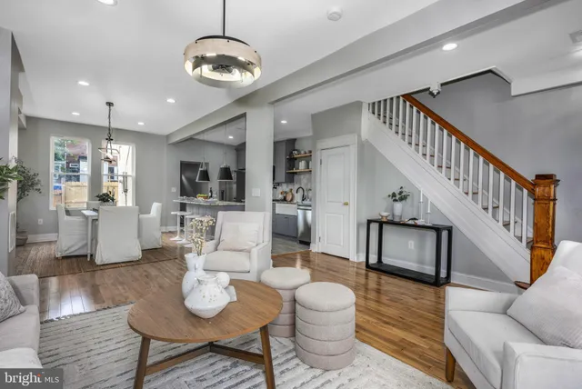 a living room with furniture and a chandelier