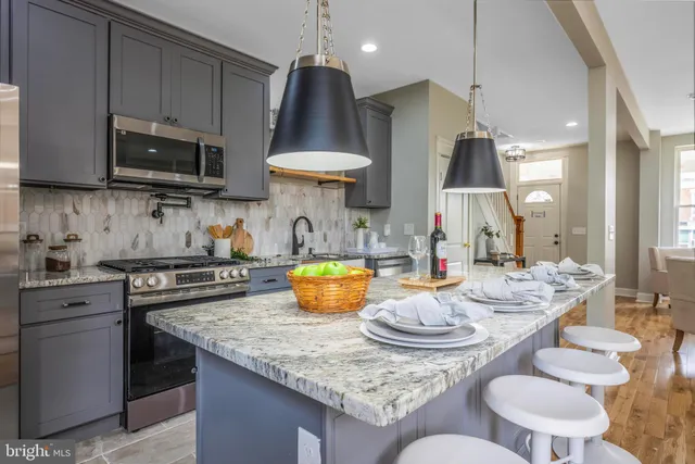 a kitchen with a stove a sink and a stove