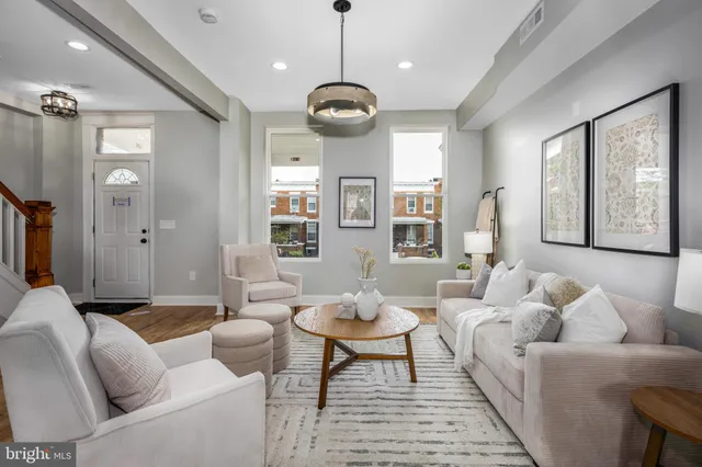 a living room with furniture a window and a chandelier