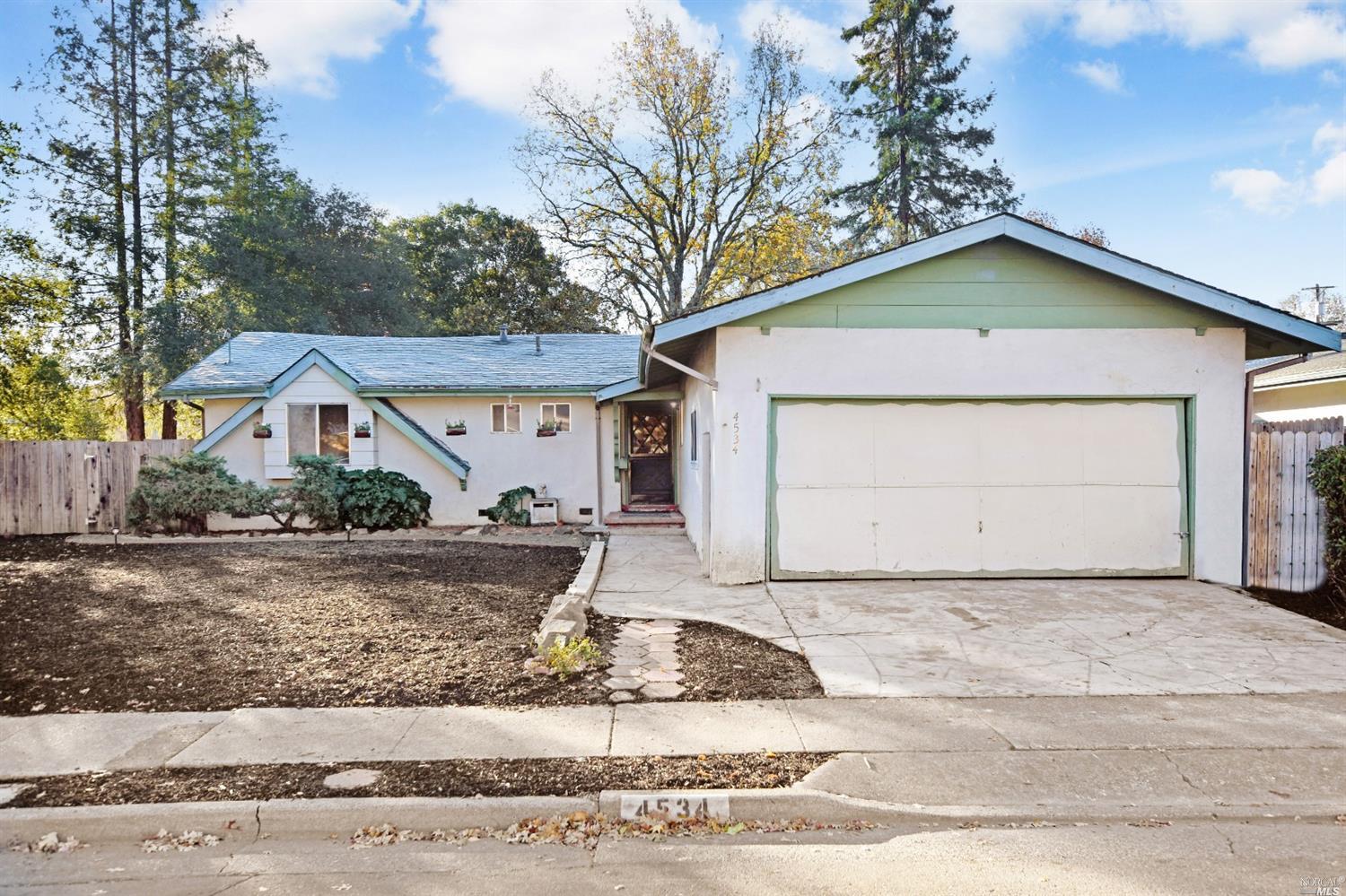 4534 Rinconada Drive Santa Rosa, CA 95409 - Photo 1 of 1 a front view of a house with a yard and garage