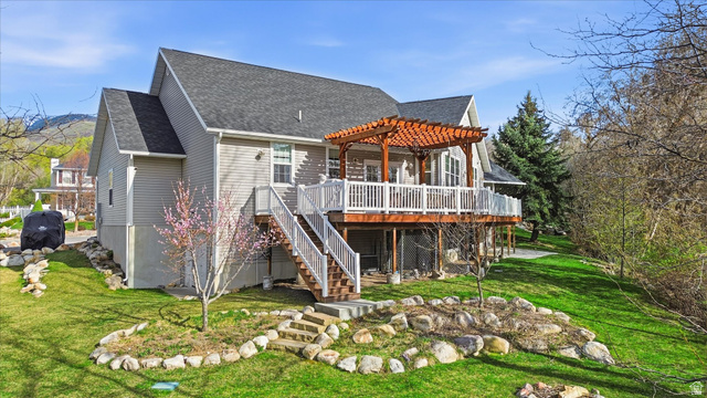 353 Robin Street Smithfield, UT 84335 - Photo 48 of 70 Back of house featuring roof with shingles, a wooden deck, a lawn, and a pergola
