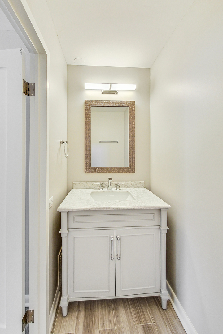 155 North Harbor Drive, Unit 4804 Chicago, IL 60601 - Photo 17 of 31 a utility room with a sink and a mirror