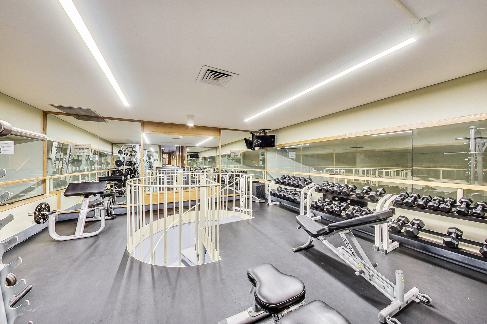 155 North Harbor Drive, Unit 4804 Chicago, IL 60601 - Photo 21 of 31 a room with lots of wooden furniture and windows