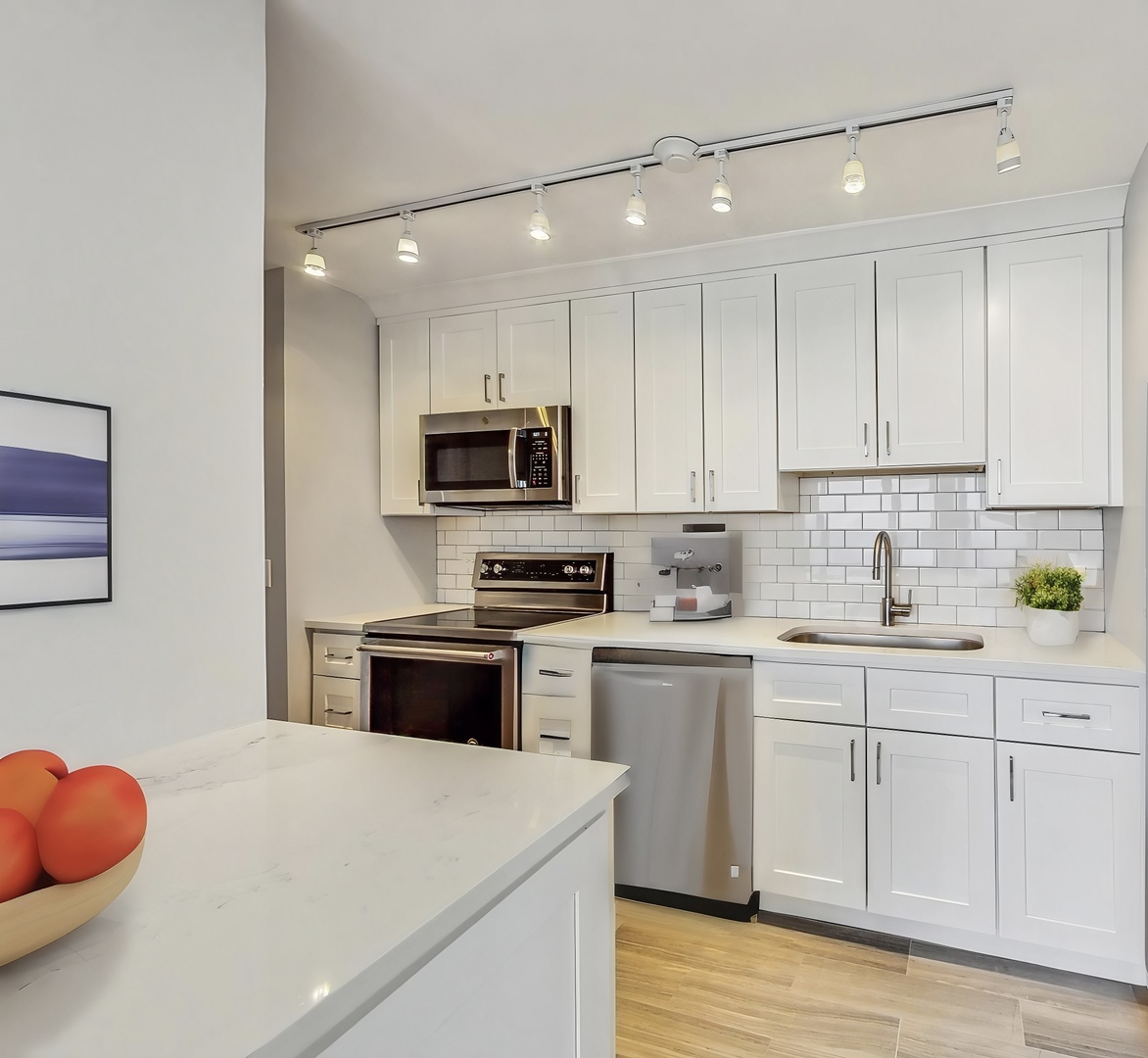 155 North Harbor Drive, Unit 4804 Chicago, IL 60601 - Photo 6 of 31 a kitchen with a sink cabinets and wooden floor