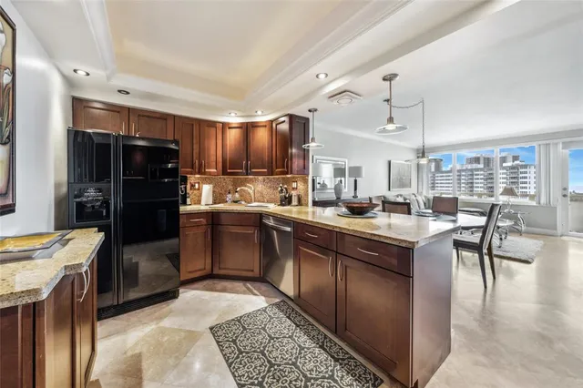 a kitchen with stainless steel appliances granite countertop a sink refrigerator and stove