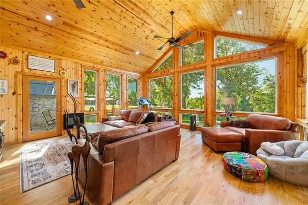 a living room with furniture and a floor to ceiling window