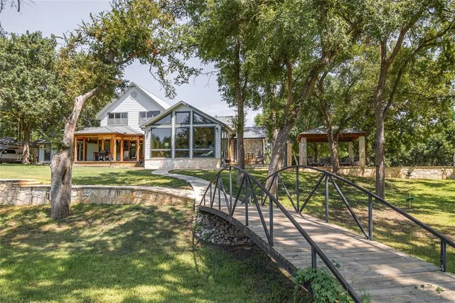 a front view of a house with a yard table and chairs