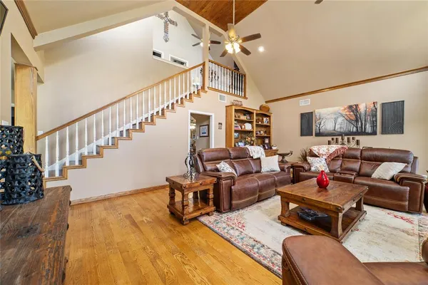 a living room with furniture or wooden floor and a chandelier