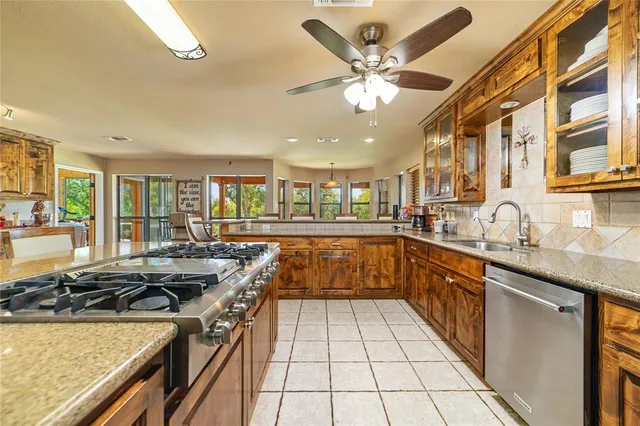 a kitchen with a sink a counter top space and stainless steel appliances