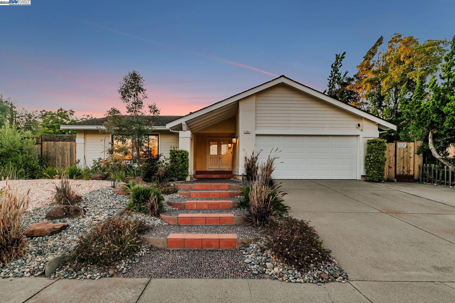 1301 Quema Drive Fremont, CA 94539 - Photo 1 of 1 a front view of a house with a yard and potted plants