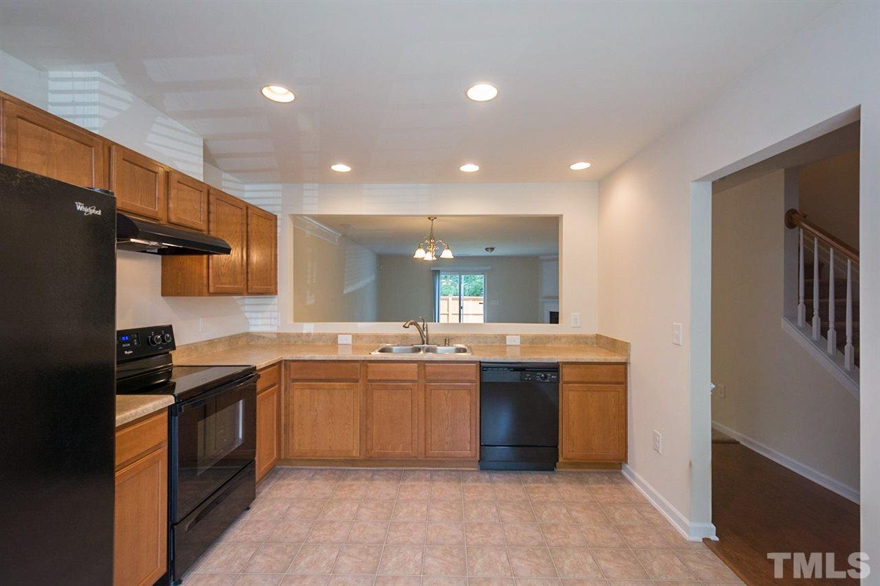 2926 Berkeley Springs Place Raleigh, NC 27616 - Photo 2 of 13 a large kitchen with stainless steel appliances granite countertop a sink and cabinets