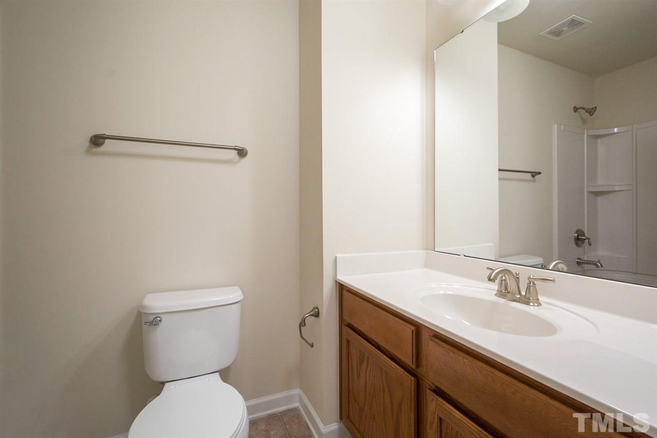 2926 Berkeley Springs Place Raleigh, NC 27616 - Photo 12 of 13 a bathroom with a sink toilet and vanity