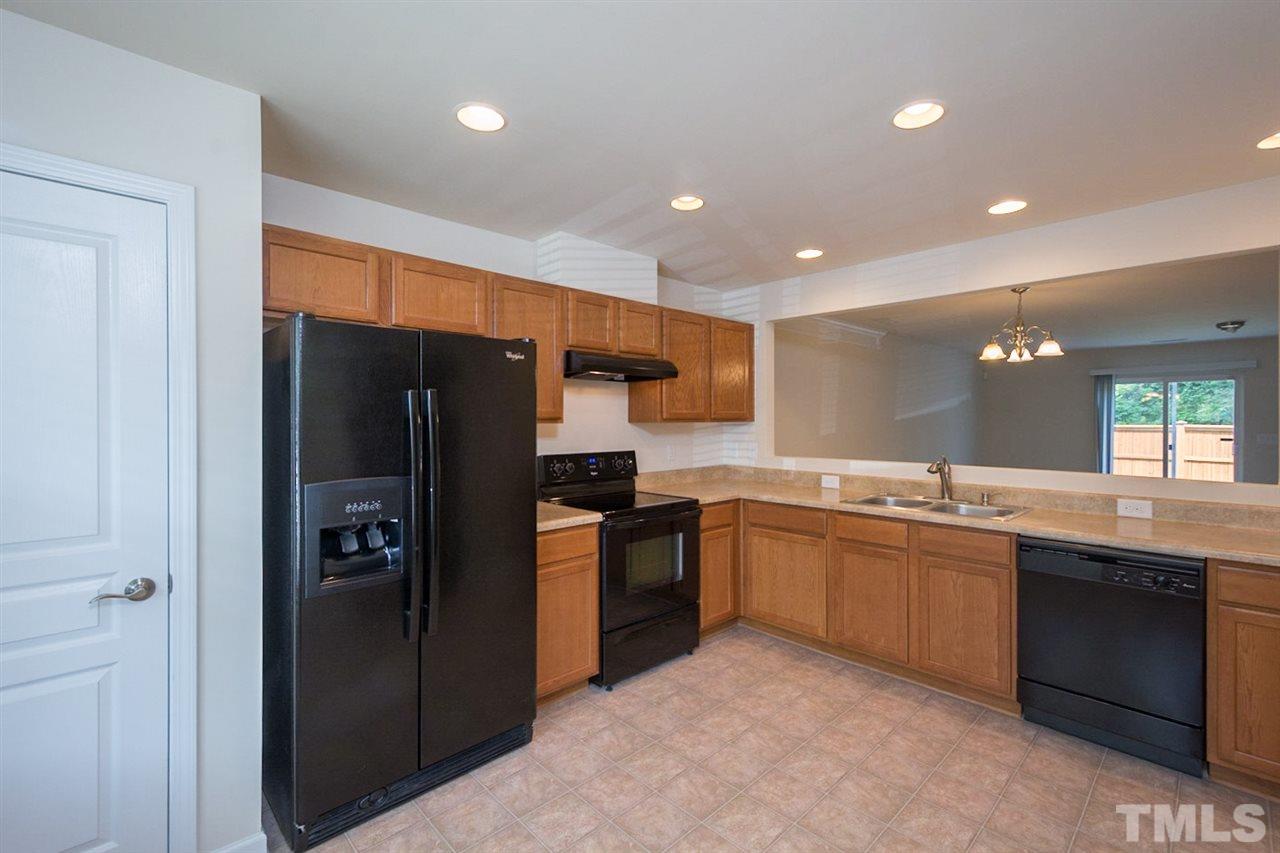 2926 Berkeley Springs Place Raleigh, NC 27616 - Photo 4 of 13 a kitchen with stainless steel appliances granite countertop refrigerator and a sink