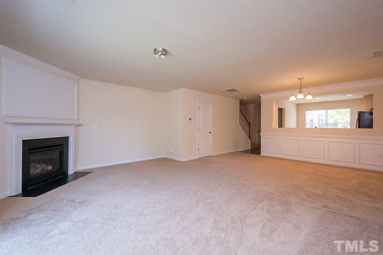 2926 Berkeley Springs Place Raleigh, NC 27616 - Photo 7 of 13 a view of an empty room with a fireplace