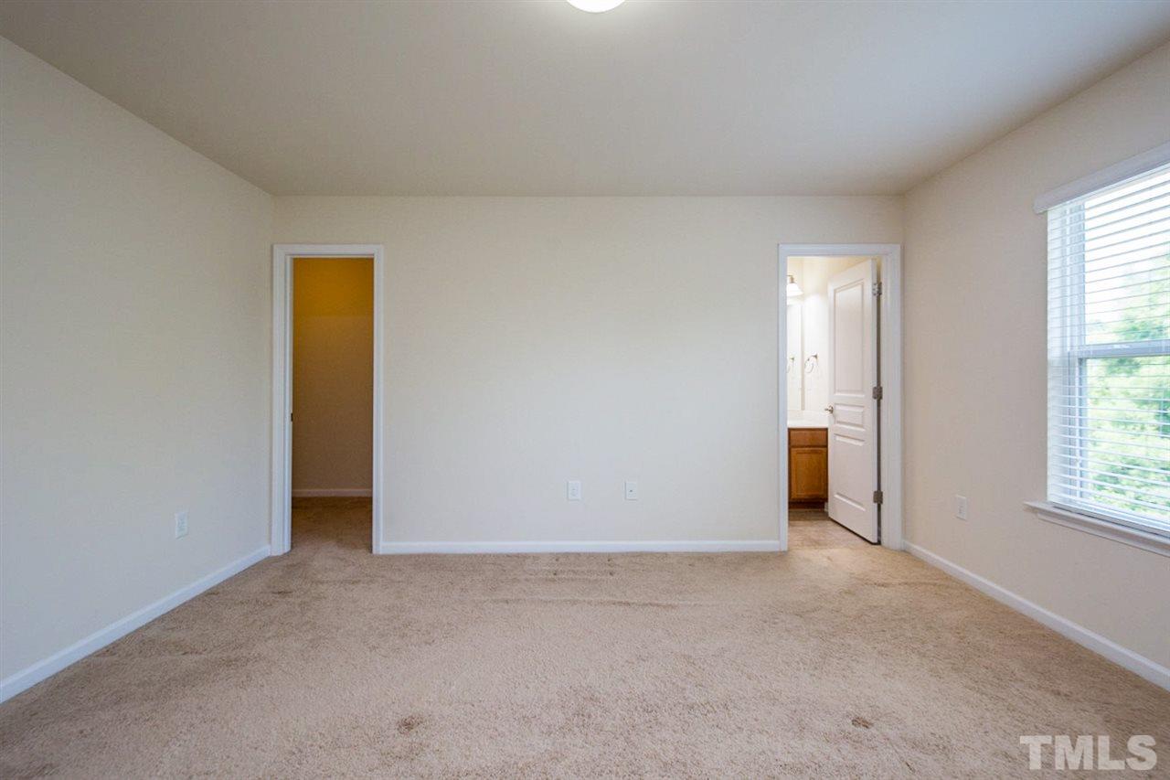 2926 Berkeley Springs Place Raleigh, NC 27616 - Photo 8 of 13 an empty room with windows and closet