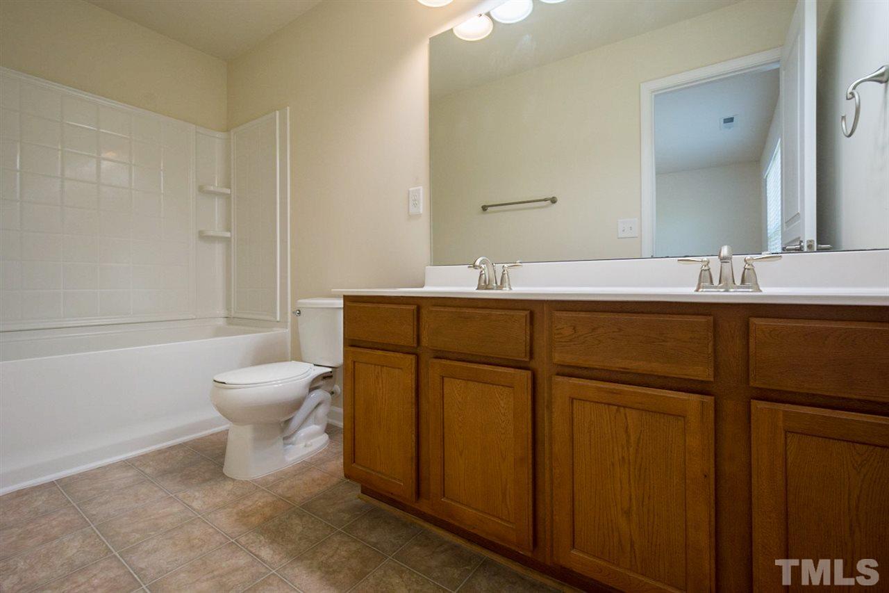 2926 Berkeley Springs Place Raleigh, NC 27616 - Photo 10 of 13 a bathroom with a toilet sink and mirror
