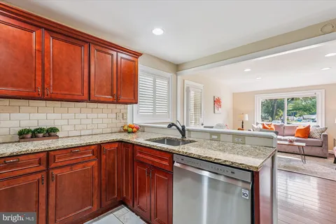 a kitchen with stainless steel appliances granite countertop a sink and cabinets