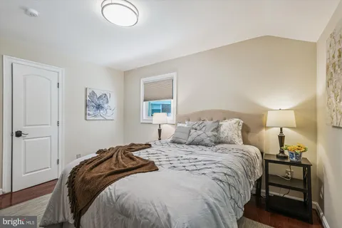 a bedroom with a bed and a lamp