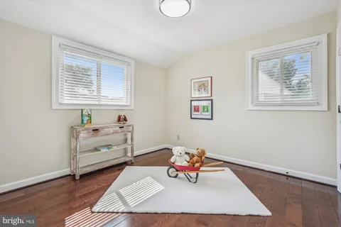 a view of a workspace with furniture and wooden floor