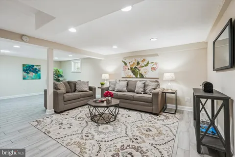 a living room with furniture a rug and a flat screen tv
