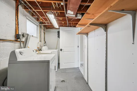 a utility room with a sink dryer and washer