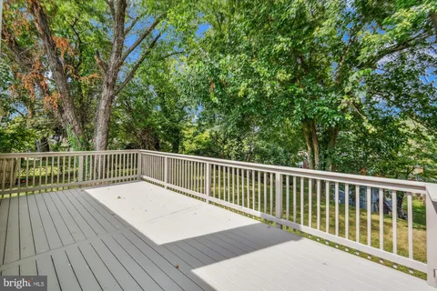 a view of balcony with wooden floor and fence