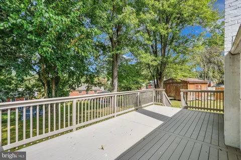 a balcony with wooden floor and fence