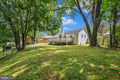 a view of house with backyard