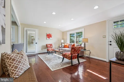 a living room with furniture and wooden floor