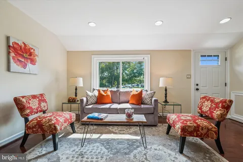 a living room with furniture lamp and rug