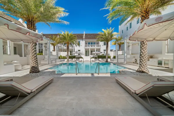 a view of a patio with swimming pool table and chairs