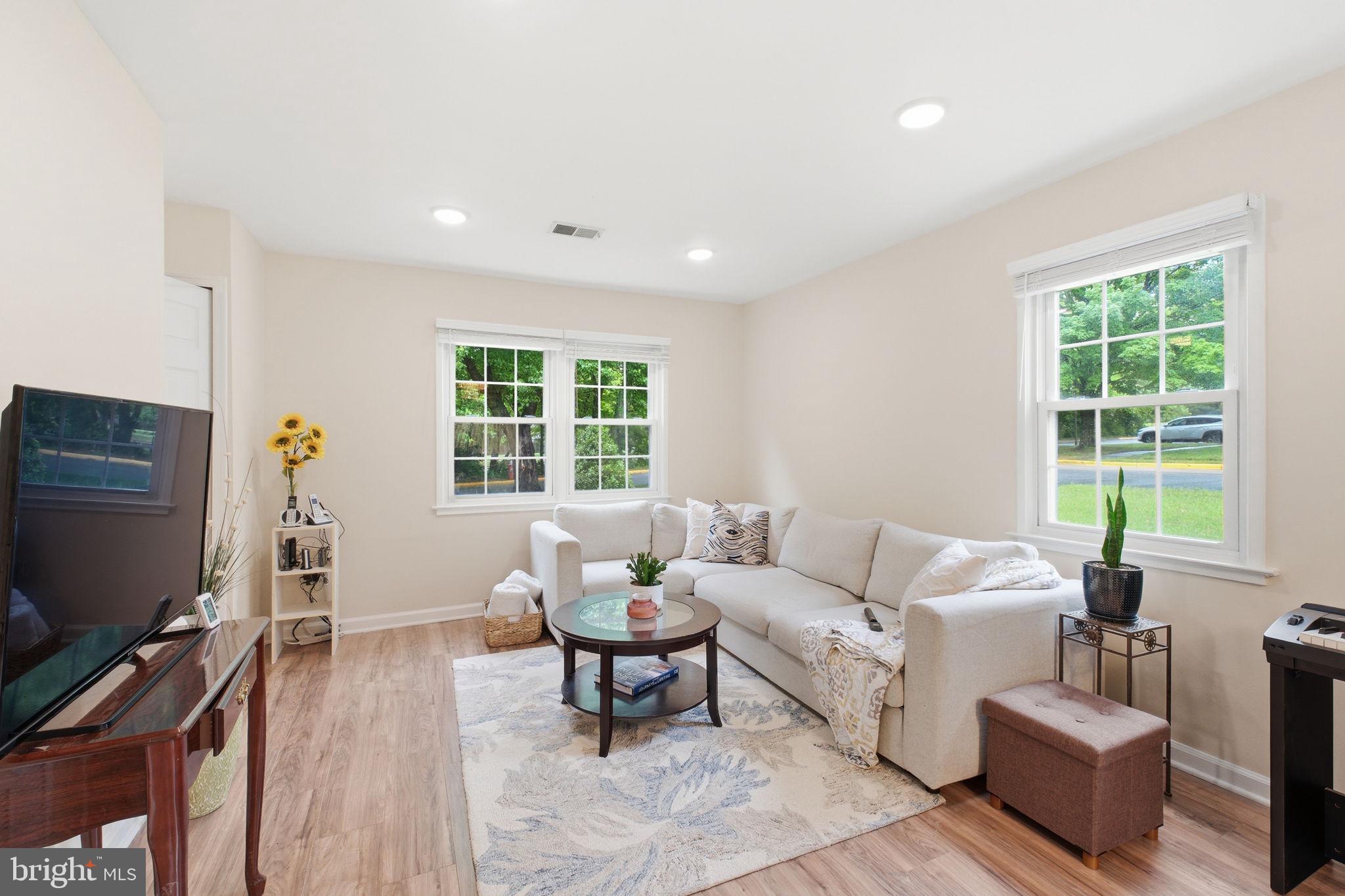 7709 Matisse Way Springfield, VA 22153 - Photo 4 of 27 Bright living room with multiple windows.