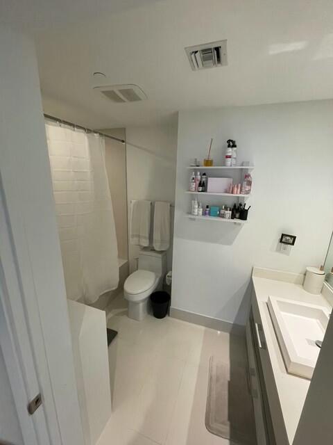 55 Southwest 9th Street, Unit 3209 Miami, FL 33130 - Photo 11 of 35 a bathroom with a sink a toilet and a shower