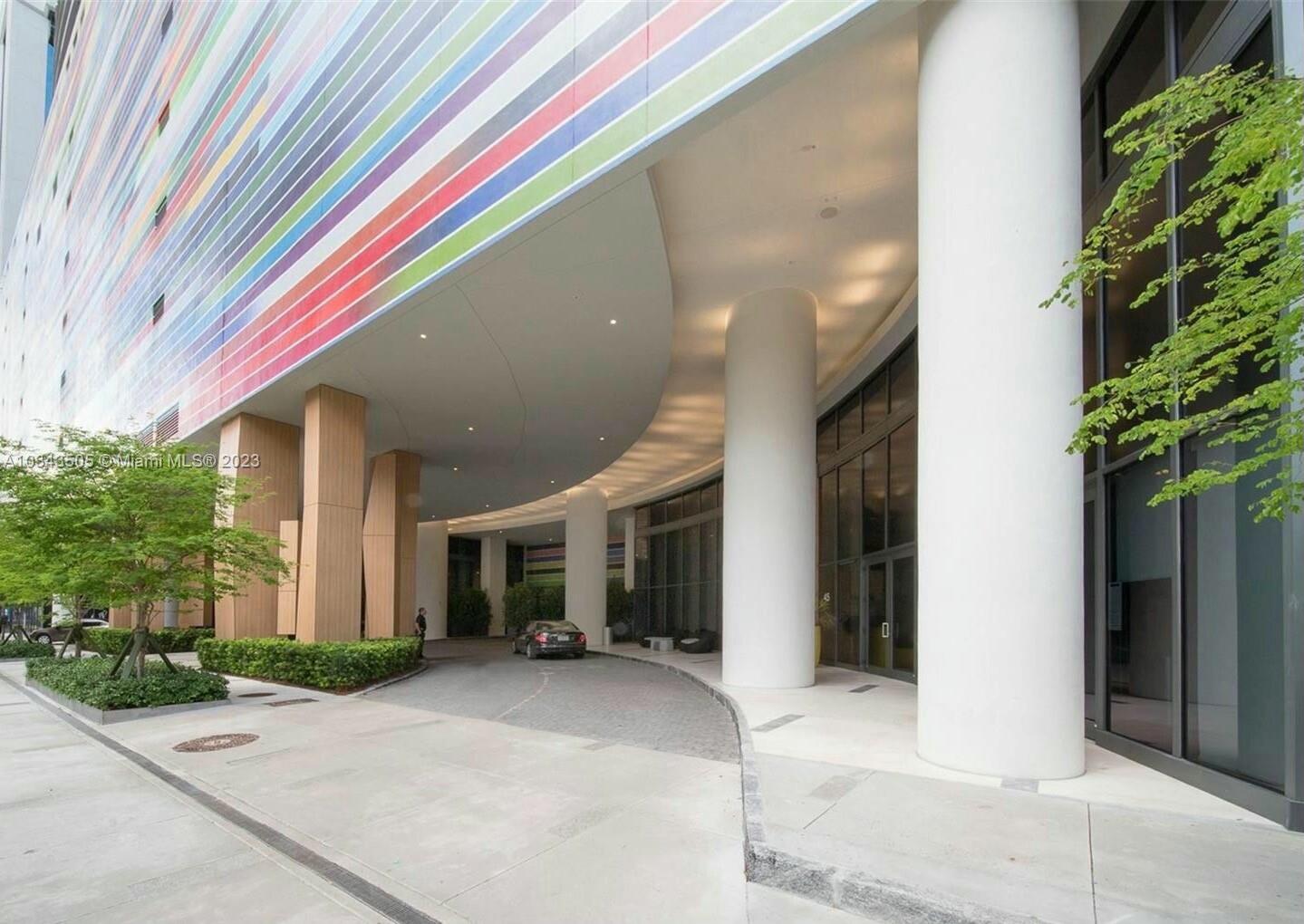 55 Southwest 9th Street, Unit 3209 Miami, FL 33130 - Photo 14 of 35 a front view of a house with a yard and potted plants