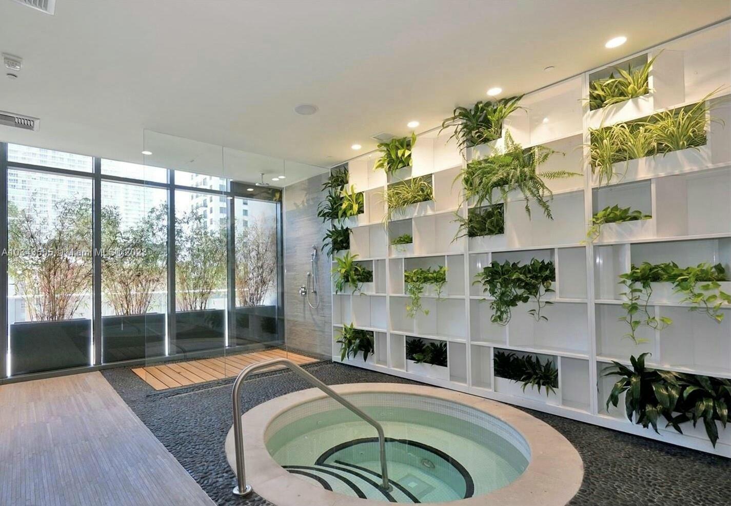 55 Southwest 9th Street, Unit 3209 Miami, FL 33130 - Photo 19 of 35 a room with chandelier fan and wooden floor