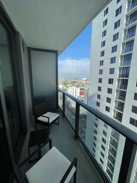 55 Southwest 9th Street, Unit 3209 Miami, FL 33130 - Photo 34 of 35 a view of a balcony with chair and wooden floor