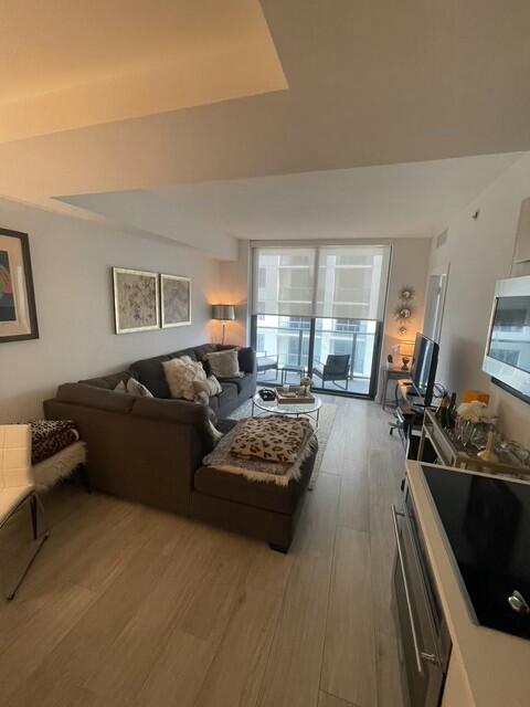 55 Southwest 9th Street, Unit 3209 Miami, FL 33130 - Photo 4 of 35 a living room with furniture and a flat screen tv