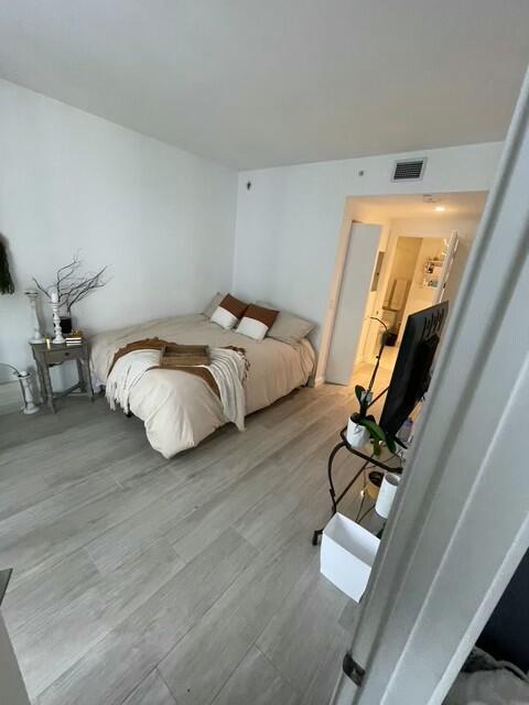 55 Southwest 9th Street, Unit 3209 Miami, FL 33130 - Photo 6 of 35 a bedroom with bed and a flat tv screen on dresser