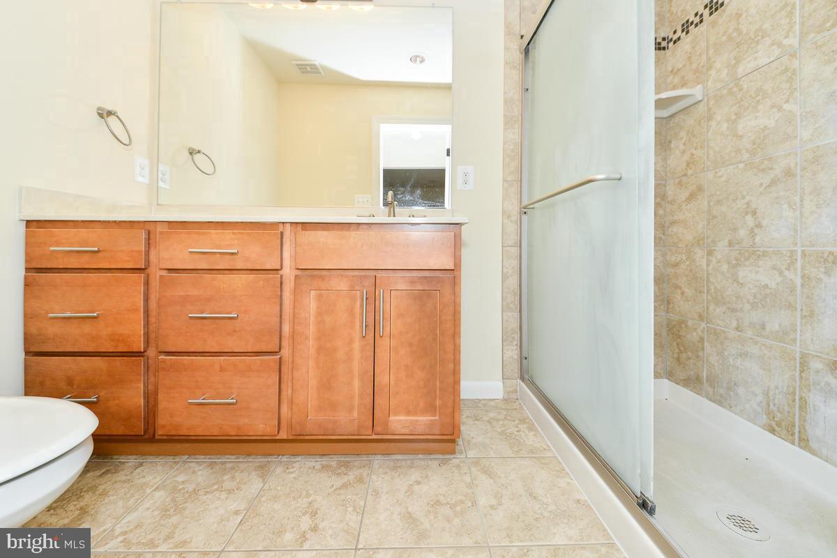 11187 Saffold Way Reston, VA 20190 - Photo 13 of 27 a bathroom with a granite countertop sink and a mirror