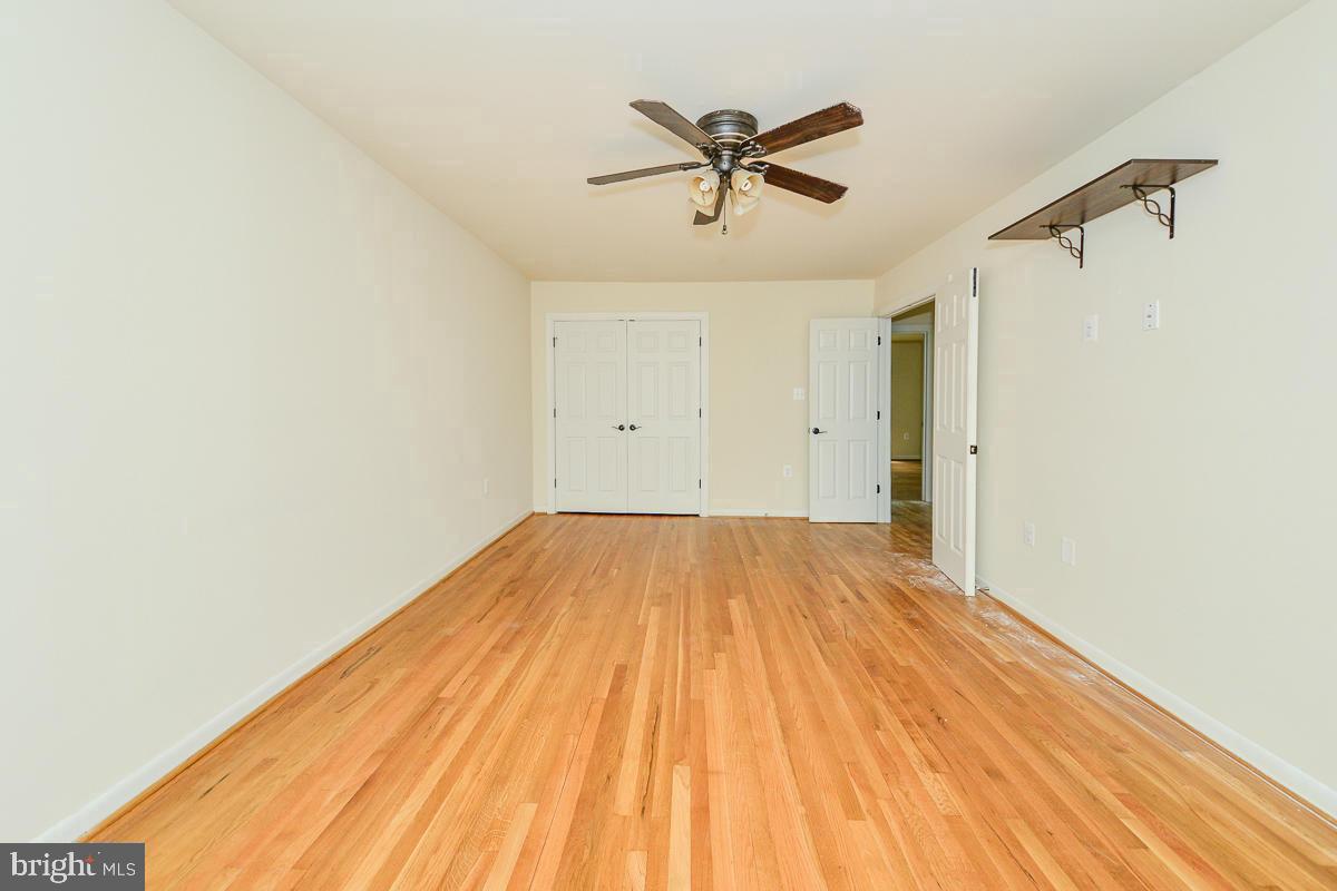 11187 Saffold Way Reston, VA 20190 - Photo 14 of 27 a view of a room with wooden floor and a ceiling fan