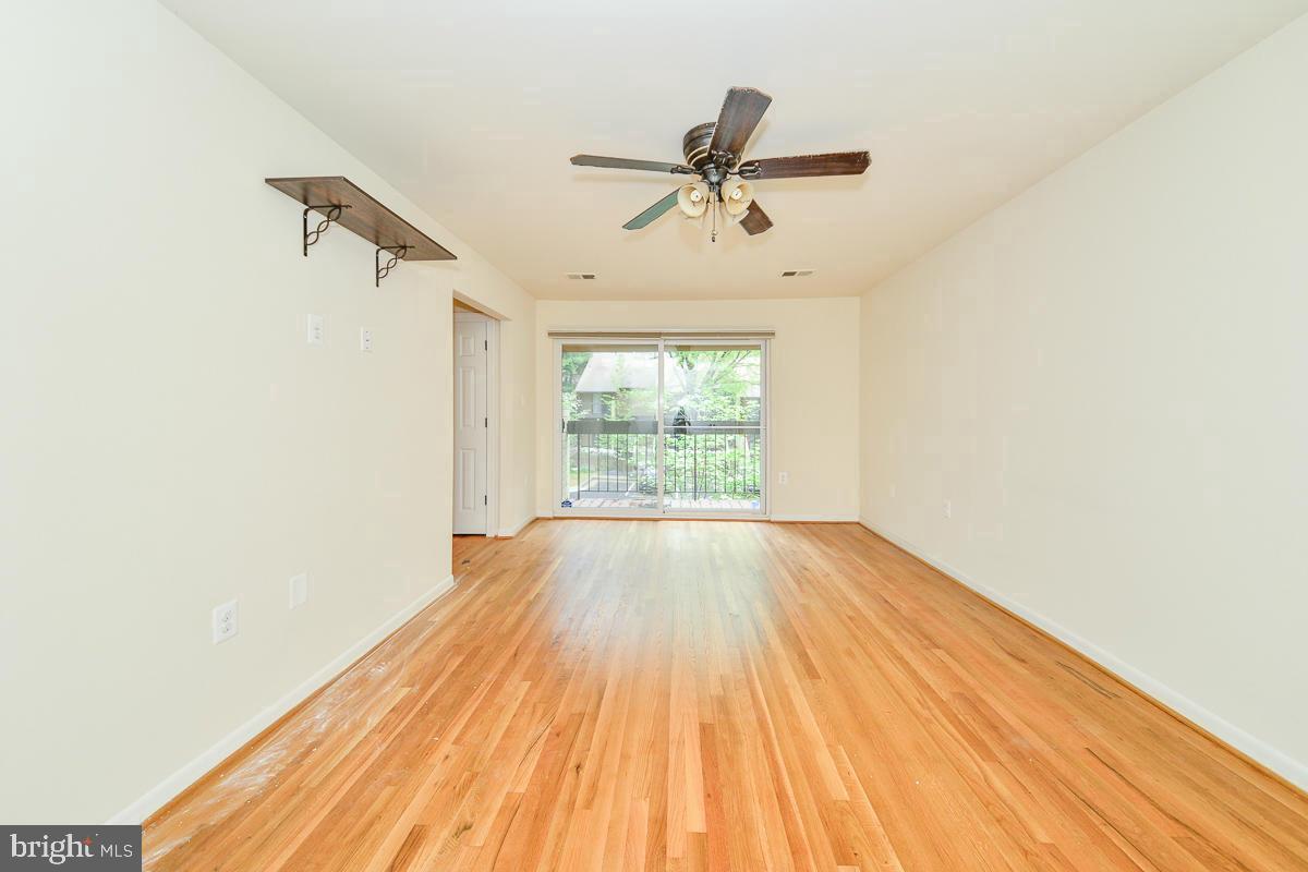 11187 Saffold Way Reston, VA 20190 - Photo 16 of 27 a view of empty room with wooden floor and fan