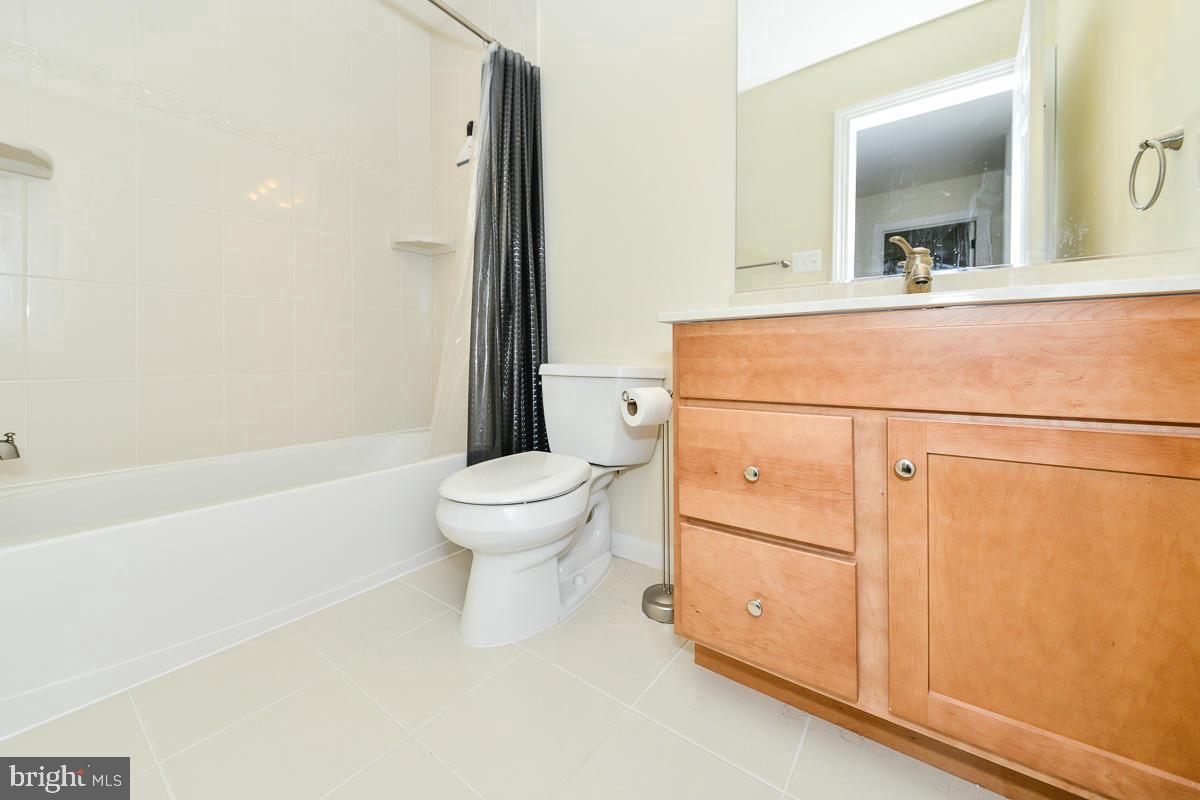 11187 Saffold Way Reston, VA 20190 - Photo 17 of 27 a bathroom with a toilet a sink and a bathtub
