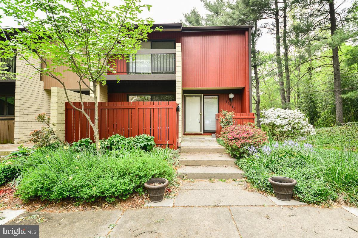11187 Saffold Way Reston, VA 20190 - Photo 2 of 27 a front view of a house with a yard