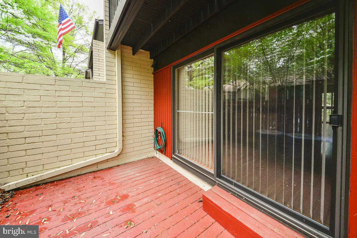 11187 Saffold Way Reston, VA 20190 - Photo 22 of 27 a view of a balcony with floor to ceiling window and wooden fence