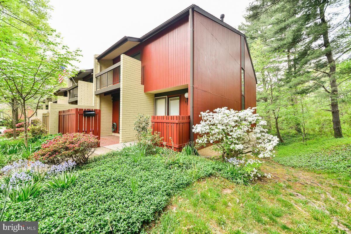 11187 Saffold Way Reston, VA 20190 - Photo 24 of 27 a front view of a house with garden