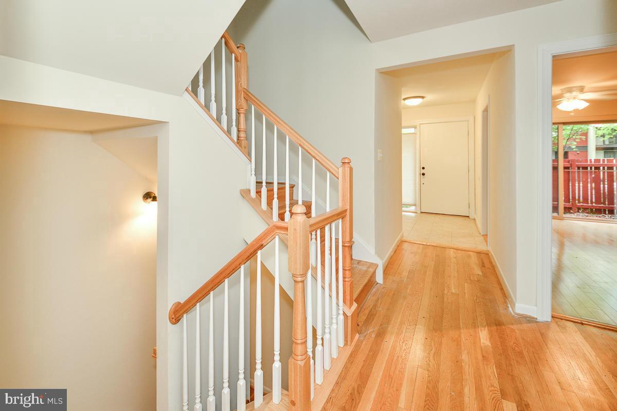 11187 Saffold Way Reston, VA 20190 - Photo 4 of 27 a view of entryway with wooden floor and stairs