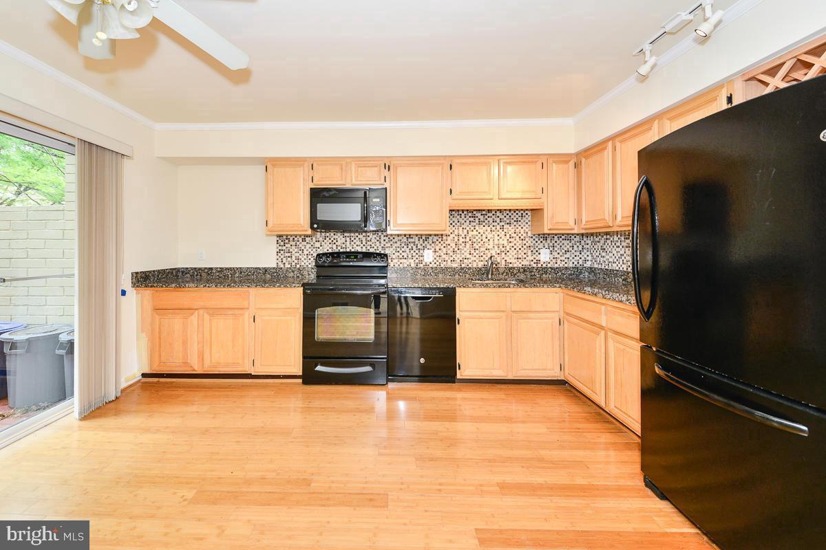 11187 Saffold Way Reston, VA 20190 - Photo 5 of 27 a kitchen with stainless steel appliances granite countertop a stove a sink and a refrigerator