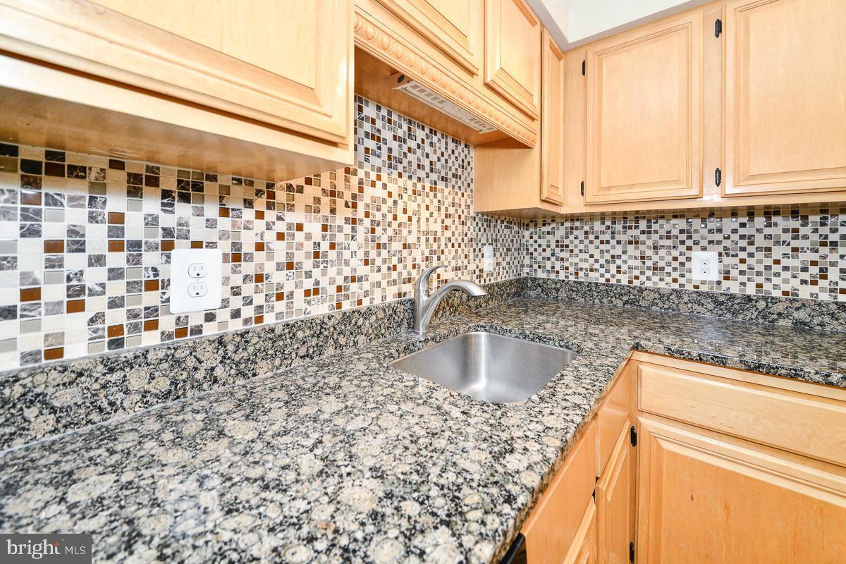 11187 Saffold Way Reston, VA 20190 - Photo 7 of 27 a kitchen with a sink a stove and cabinets