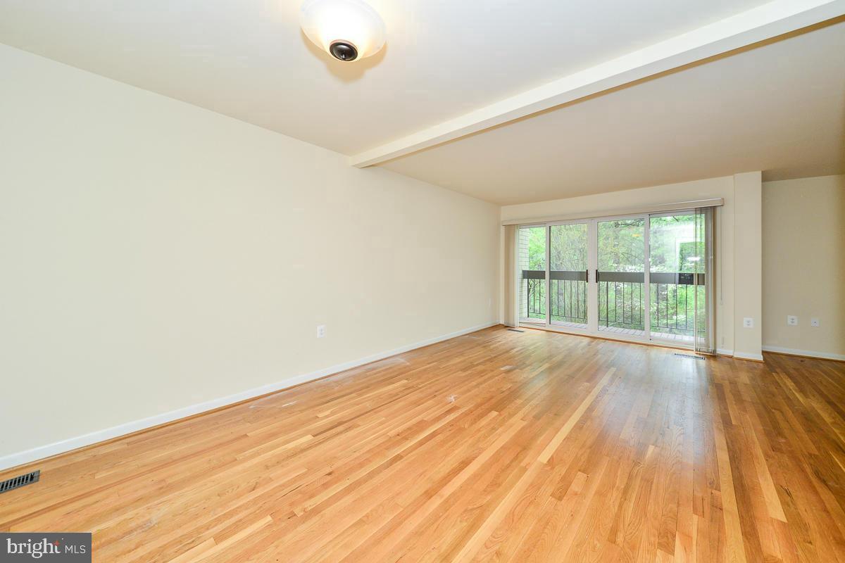 11187 Saffold Way Reston, VA 20190 - Photo 8 of 27 wooden floor in an empty room with a window